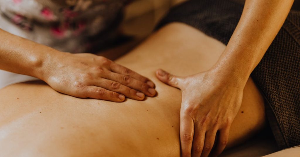 Close-up of hands giving a soothing back massage in a calm atmosphere.